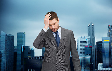 Image showing young businessman having headache