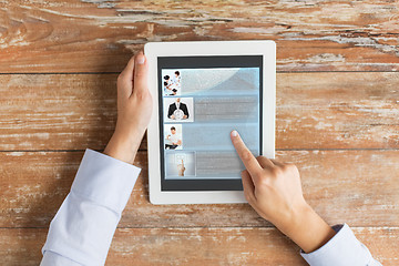 Image showing close up of male hands showing blog on tablet pc