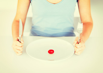 Image showing woman with plate and one tomato