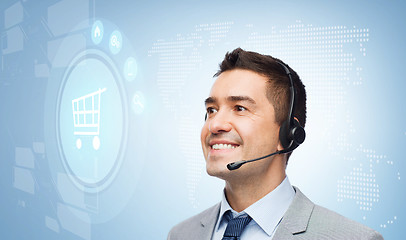 Image showing businessman with headset and shopping trolley icon