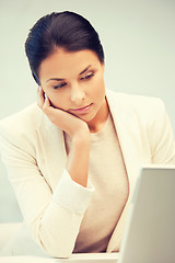 Image showing pensive woman with laptop computer