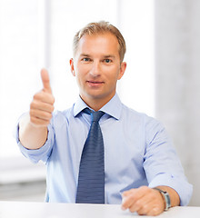 Image showing smiling businessman showing thumbs up