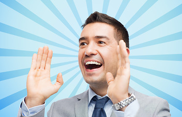 Image showing happy businessman in suit shouting