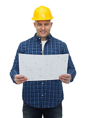 Image showing smiling male builder in helmet with blueprint