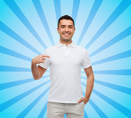 Image showing smiling man in t-shirt pointing finger on himself