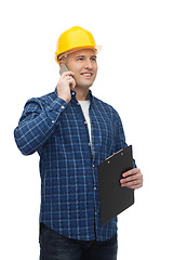 Image showing smiling male builder in helmet with clipboard