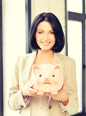 Image showing lovely woman with piggy bank