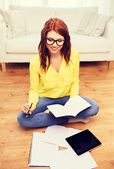 Image showing smiling teenage girl with tablet pc at home