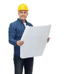 Image showing smiling male builder in helmet with blueprint