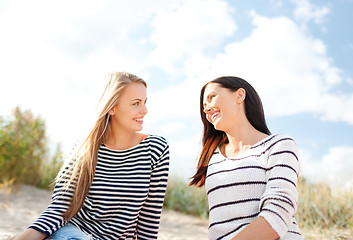 Image showing happy teenage girls or young women on beach