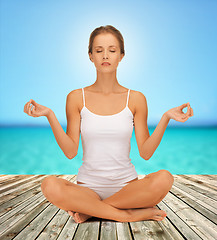 Image showing woman  meditating in yoga lotus pose 