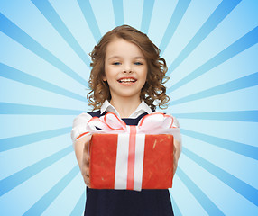 Image showing happy girl with red gift box over blue