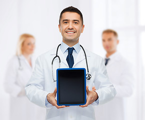 Image showing smiling male doctor with tablet pc at hospital