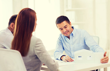 Image showing couple looking at model of their house at office