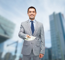 Image showing smiling businessman with american dollar money