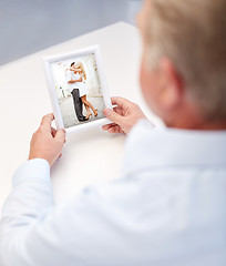 Image showing close up of old man holding young couple photo