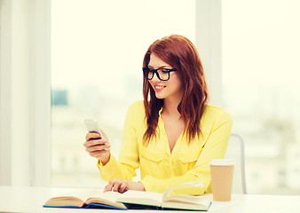 Image showing smiling student girl with smartphone at school