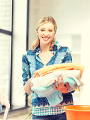 Image showing lovely housewife with towels