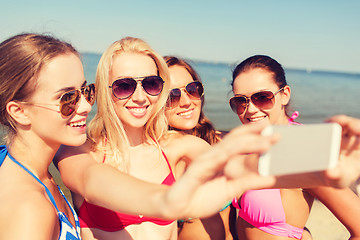 Image showing group of smiling women making selfie on beach