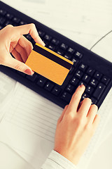 Image showing businesswoman with laptop using credit card