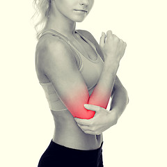 Image showing sporty woman with pain in elbow