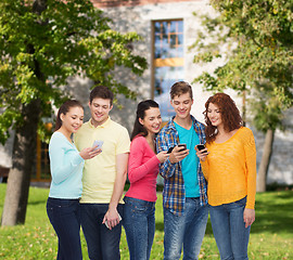 Image showing group of smiling teenagers with smartphones