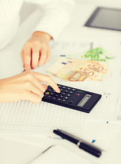 Image showing woman hand with calculator and euro money