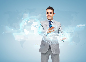 Image showing happy businessman working with virtual screens