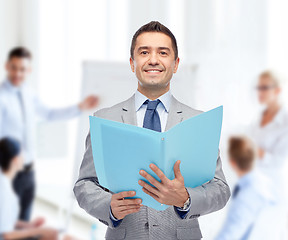 Image showing happy businessman with open folder