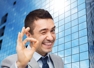 Image showing happy businessman in suit showing ok hand sign