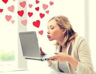 Image showing woman sending kisses with laptop computer