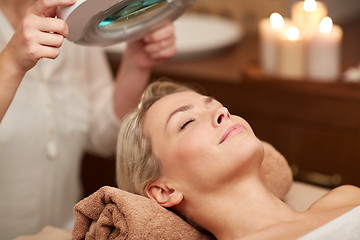 Image showing close up of young woman lying in spa