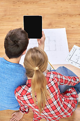 Image showing close up of couple with tablet pc and blueprints