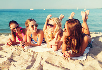 Image showing group of smiling women in sunglasses on beach