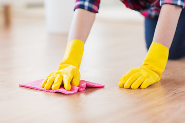 Image showing close up of woman with rag cleaning floor at home