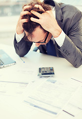 Image showing businessman with papres, laptop and calculator