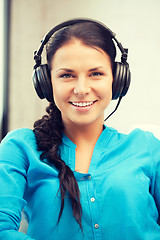 Image showing happy teenage girl in big headphones