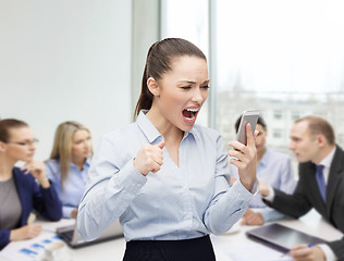 Image showing screaming businesswoman with smartphone