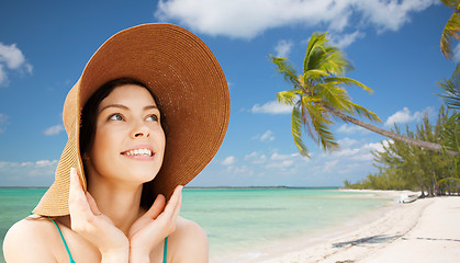 Image showing happy young woman in straw hat on tropical beach