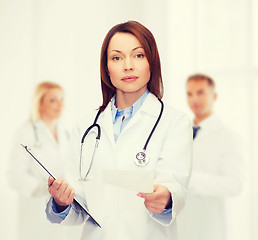 Image showing calm female doctor with clipboard