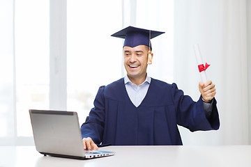 Image showing smiling adult student in mortarboard with diploma