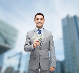 Image showing smiling businessman with american dollar money