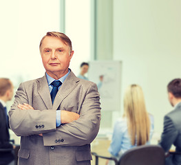 Image showing serious businessman or teacher in suit at office