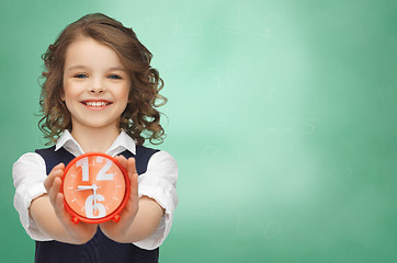 Image showing happy girl with alarm clock 