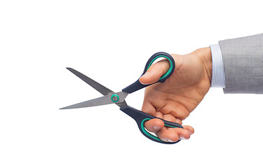 Image showing close up of businessman hand holding scissors