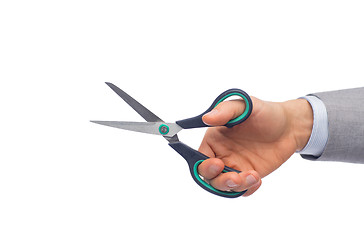 Image showing close up of businessman hand holding scissors