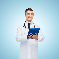 Image showing smiling male doctor in white coat with tablet pc