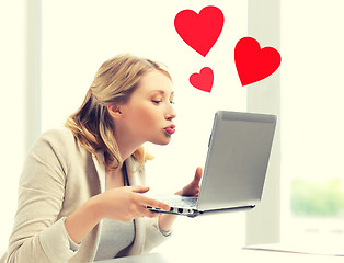 Image showing woman sending kisses with laptop computer