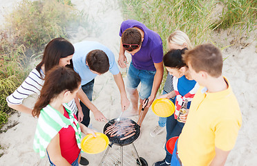 Image showing group of friends having picnic on beach