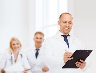 Image showing smiling male doctor with clipboard